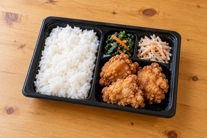 唐揚げとごはん、野菜を詰めた持ち帰り弁当
